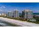 Gorgeous aerial view of beachfront condos with pristine sands and inviting turquoise waters at 1560 Gulf Blvd # 1104, Clearwater Beach, FL 33767
