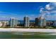 Aerial view of beachfront condos along a stunning white sand beach and sparkling ocean at 1560 Gulf Blvd # 1104, Clearwater Beach, FL 33767