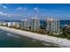 Aerial view of beachfront condos and pristine sands, offering a luxurious coastal lifestyle at 1560 Gulf Blvd # 1104, Clearwater Beach, FL 33767