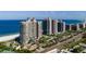 Expansive aerial view of luxury high-rise condos with beach access, tennis courts, and beautiful surroundings at 1560 Gulf Blvd # 1104, Clearwater Beach, FL 33767