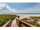 A wooden walkway leads to a pristine beach at 1560 Gulf Blvd # 1104, Clearwater Beach, FL 33767