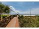 Beach access from a wooden walkway provides a serene path to the sandy shores at 1560 Gulf Blvd # 1104, Clearwater Beach, FL 33767