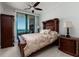 Cozy bedroom features a well-appointed bed, complemented by ocean views and stylish dark wood furniture at 1560 Gulf Blvd # 1104, Clearwater Beach, FL 33767