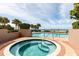 Inviting hot tub and pool area with lush landscaping and ocean views, perfect for relaxation at 1560 Gulf Blvd # 1104, Clearwater Beach, FL 33767