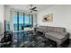 Bright living room featuring black marble floors, modern furnishings, and stunning ocean views at 1560 Gulf Blvd # 1104, Clearwater Beach, FL 33767