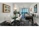 Elegant living room with black marble floors, modern chandelier, and ocean views creates a luxurious atmosphere at 1560 Gulf Blvd # 1104, Clearwater Beach, FL 33767