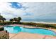 Relaxing in-ground pool surrounded by comfortable lounge chairs with picturesque views of the ocean at 1560 Gulf Blvd # 1104, Clearwater Beach, FL 33767