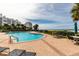 A pool sits between the building and the beautiful beach in this photo at 1560 Gulf Blvd # 1104, Clearwater Beach, FL 33767