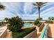 Inviting pool and landscaped area offers a relaxing beachfront atmosphere with palm trees and beach views at 1560 Gulf Blvd # 1104, Clearwater Beach, FL 33767
