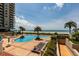 Luxurious pool area with palm trees and lounge chairs, offering direct beach access and beautiful ocean views at 1560 Gulf Blvd # 1104, Clearwater Beach, FL 33767
