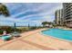 Inviting community pool with lounge chairs overlooking the ocean, perfect for relaxation at 1560 Gulf Blvd # 1104, Clearwater Beach, FL 33767