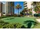 Well-maintained putting green nestled among palm trees and lush greenery, perfect for golf enthusiasts at 1560 Gulf Blvd # 1104, Clearwater Beach, FL 33767