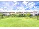 A large, fenced backyard showcasing lush green grass and well-maintained landscaping at 17805 Everlong Dr, Land O Lakes, FL 34638