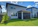 Well-maintained backyard featuring a screened lanai, lush lawn, and partial fencing at 17805 Everlong Dr, Land O Lakes, FL 34638