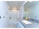 Clean bathroom with a shower-tub combo, a single sink vanity, and a large mirror at 17805 Everlong Dr, Land O Lakes, FL 34638