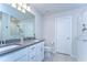 Bright bathroom featuring double sinks, a walk-in shower, neutral walls, and tile floors for convenience and modern appeal at 17805 Everlong Dr, Land O Lakes, FL 34638