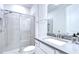Modern bathroom featuring a tiled shower with glass door and a gray quartz countertop vanity at 17805 Everlong Dr, Land O Lakes, FL 34638