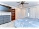 Cozy bedroom with a ceiling fan, gray dresser, carpeted floors, and window that provides natural light at 17805 Everlong Dr, Land O Lakes, FL 34638