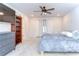 Cozy bedroom with a ceiling fan, gray dresser, carpeted floors, and window that provides natural light at 17805 Everlong Dr, Land O Lakes, FL 34638