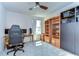This bedroom includes a ceiling fan, office chair, wooden desk, and well-lit window, perfect for any homeowner at 17805 Everlong Dr, Land O Lakes, FL 34638