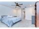 The well-lit bedroom features a ceiling fan, soft carpet, window, and gray dresser, perfect for any homeowner at 17805 Everlong Dr, Land O Lakes, FL 34638