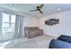 Upstairs bonus room with neutral carpet, a couch, and a window letting in natural light at 17805 Everlong Dr, Land O Lakes, FL 34638