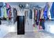 Organized closet with rods, shelves, a safe for valuables, and an assortment of clothing for ample storage at 17805 Everlong Dr, Land O Lakes, FL 34638