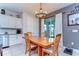 Inviting dining room with a modern chandelier, a wooden dining table, and white cabinets at 17805 Everlong Dr, Land O Lakes, FL 34638
