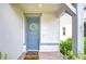 Inviting covered entryway with a blue front door adorned with a decorative wreath at 17805 Everlong Dr, Land O Lakes, FL 34638