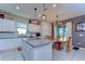 Bright kitchen featuring white cabinets, stainless steel appliances and an island at 17805 Everlong Dr, Land O Lakes, FL 34638