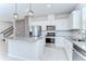 Bright kitchen featuring white cabinets, stainless steel appliances, gray counter tops, tile flooring and backsplash at 17805 Everlong Dr, Land O Lakes, FL 34638