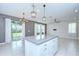 Open kitchen island with gray counter tops and white cabinets in a brightly lit room at 17805 Everlong Dr, Land O Lakes, FL 34638