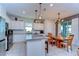 Well-lit kitchen with white cabinetry, stainless appliances, and center island at 17805 Everlong Dr, Land O Lakes, FL 34638