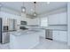 Bright kitchen featuring white cabinets, stainless steel appliances, gray counter tops, tile flooring and backsplash at 17805 Everlong Dr, Land O Lakes, FL 34638