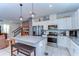 Modern kitchen with gray countertops, stainless steel appliances, and a breakfast bar with seating at 17805 Everlong Dr, Land O Lakes, FL 34638
