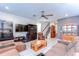 Cozy living room with a large sectional sofa, tile flooring, and staircase at 17805 Everlong Dr, Land O Lakes, FL 34638