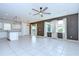 Spacious living area with tile flooring, a ceiling fan, and modern pendant lights at 17805 Everlong Dr, Land O Lakes, FL 34638