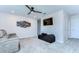 This living room features a ceiling fan, mounted TV, sofa, and ample space for relaxation and entertainment at 17805 Everlong Dr, Land O Lakes, FL 34638