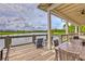 Spacious covered patio overlooking a serene lake, complete with comfortable seating and dining areas at 17805 Everlong Dr, Land O Lakes, FL 34638