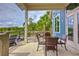 Charming outdoor patio area with comfortable seating overlooking a serene lake and lush landscaping at 17805 Everlong Dr, Land O Lakes, FL 34638