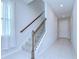 Staircase with decorative railing and carpeted steps leading to the upper level at 17805 Everlong Dr, Land O Lakes, FL 34638