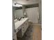 Bright bathroom with white cabinets, tile floors, and shower with white curtain at 1810 E Palm Ave # 7104, Tampa, FL 33605