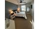 Cozy bedroom featuring a ceiling fan, large window, and neutral walls at 1810 E Palm Ave # 7104, Tampa, FL 33605