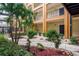 Charming courtyard features lush landscaping, decorative rocks, and easy access to apartments in a secure building at 1810 E Palm Ave # 7104, Tampa, FL 33605