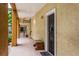 Inviting hallway with tiled floor, bench, and unit entrance showcases the building's warm exterior color palette at 1810 E Palm Ave # 7104, Tampa, FL 33605