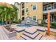Hot tub offers a cozy relaxation spot with elegant tiling, seating area, and a nearby garden at 1810 E Palm Ave # 7104, Tampa, FL 33605