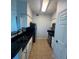 Galley kitchen includes stainless steel appliances, dark granite counters, and white cabinets at 1810 E Palm Ave # 7104, Tampa, FL 33605