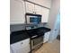 Well-lit kitchen features stainless steel appliances, granite countertops, and white cabinetry at 1810 E Palm Ave # 7104, Tampa, FL 33605