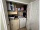 Functional laundry room featuring washer, dryer, and storage shelves at 1810 E Palm Ave # 7104, Tampa, FL 33605