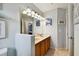 Bathroom with double sinks, granite countertops, a large vanity mirror, and light-filled at 20145 Bay Cedar Ave, Tampa, FL 33647